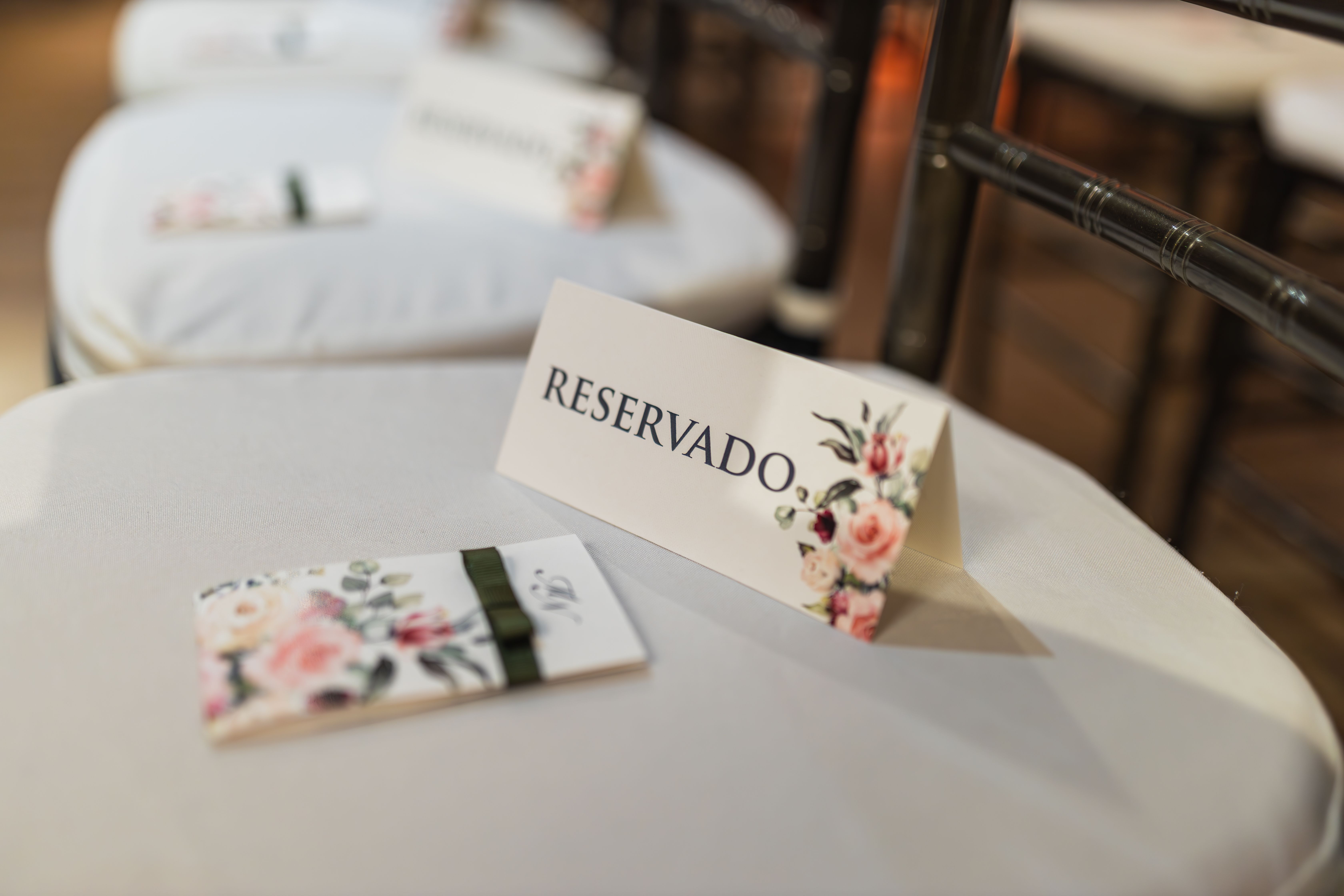 Silla reservada con tarjeta floral en evento